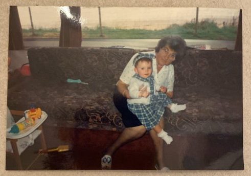 An old photograph of a woman and small child.