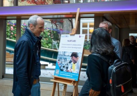 two males and a female talking to each other at the event reception