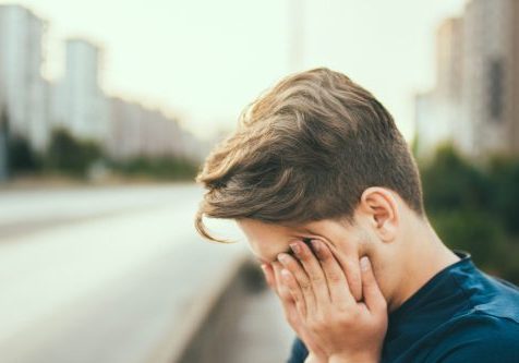 Young man with head in his hands