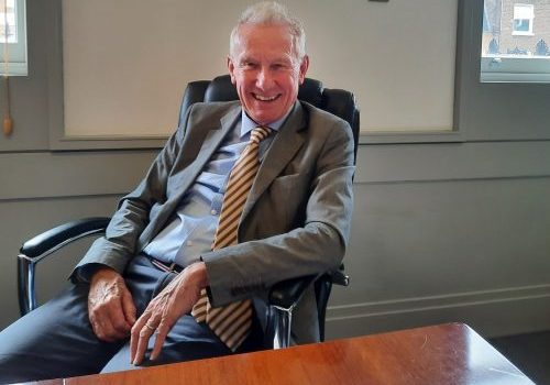 Professor John Cunningham sat at his desk