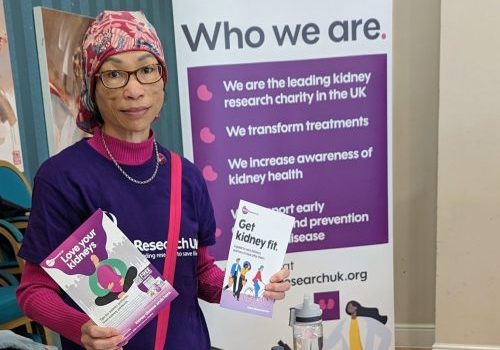 Female volunteer sharing leaflets and information to raise awareness of kidney disease
