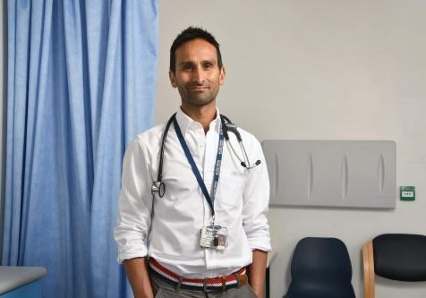 An Asian man, earing a white shirt with a stethoscope