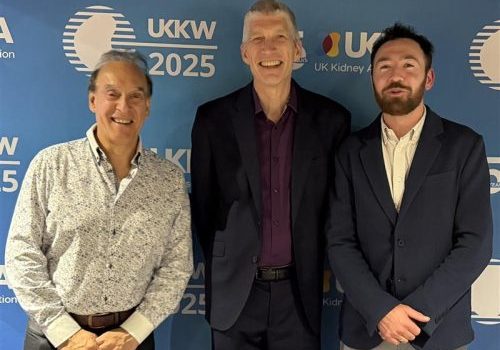 Professor Maarten Taal Three men standing next to each other in front of a background with UKKW logos on it.