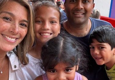 Family selfie of mum, dad and three little children.