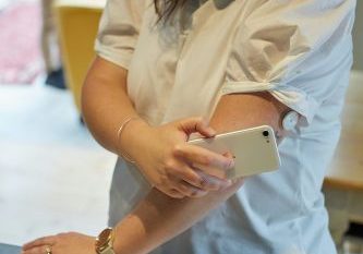Young South African woman with Type 1 diabetes scanning blood glucose with a flash glucose monitor.