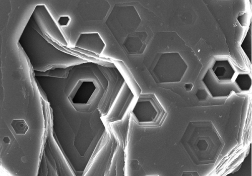 Close-up view of snowflake structures showing hexagonal shapes and intricate details.