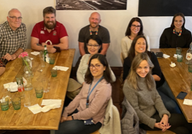 group of males and females from the University of Bristol, sitting around two tables